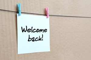 Welcome back! Note is written on a white sticker that hangs with