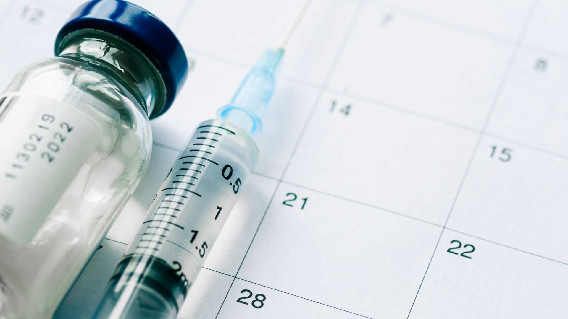 vial-with-vaccine-and-syringe-on-calendar